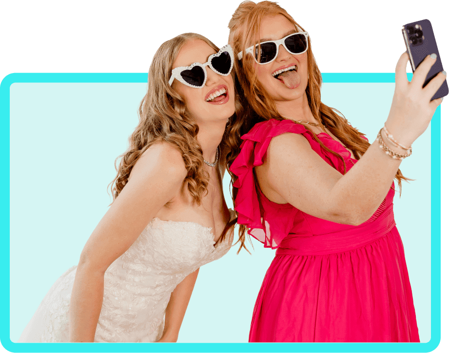 A bride and wedding guest taking a selfie